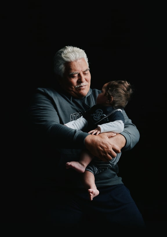 John Forbes holds one of his Mokopuna