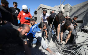 Rescuers search for survivors under the rubble a day after an Israeli airstrike in Beirut's southern suburb of Jnah on October 22, 2024, amid the ongoing war between Israel and Hezbollah. (Photo by IBRAHIM AMRO / AFP)
