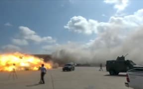 A video grab shows the moment an ordnance hit the airport in the southern Yemeni port city of Aden on December 30, 2020.