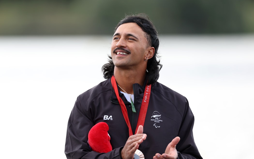 PARIS, FRANCE - SEPTEMBER 08: Bronze medalist, Peter Cowan of Team New Zealand celebrates on the podium during the medal ceremony for the Men's Va'a Single 200m VL3 on day eleven of the Paris 2024 Summer Paralympic Games at Vaires-Sur-Marne Nautical Stadium on September 08, 2024 in Paris, France. (Photo by Fiona Goodall/Getty Images for PNZ)