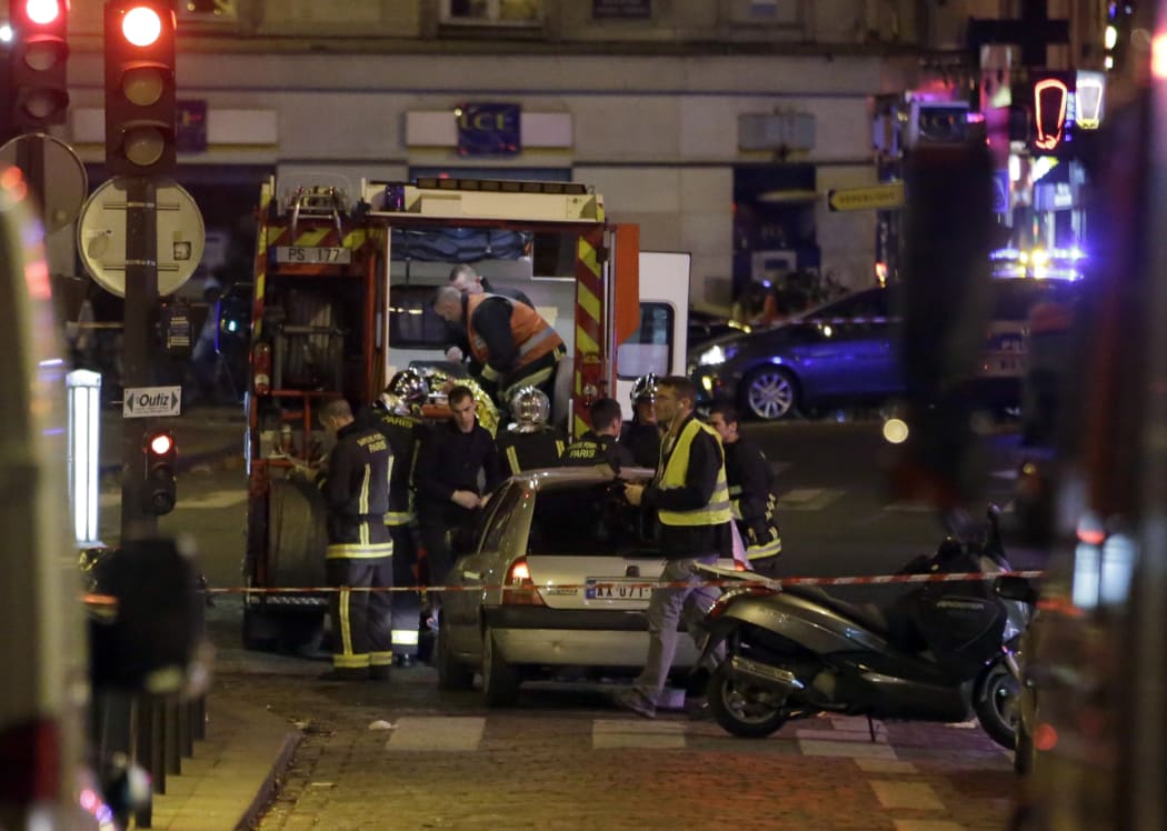 Rescue workers evacuate a man on a stretcher near the Bataclan arts centre.