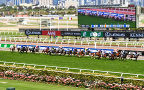 This handout photo taken and received from Racing Photos on November 3, 2020 shows the horses racing in front of empty grandstands in the Melbourne Cup at the Flemington Racecourse in Melbourne.