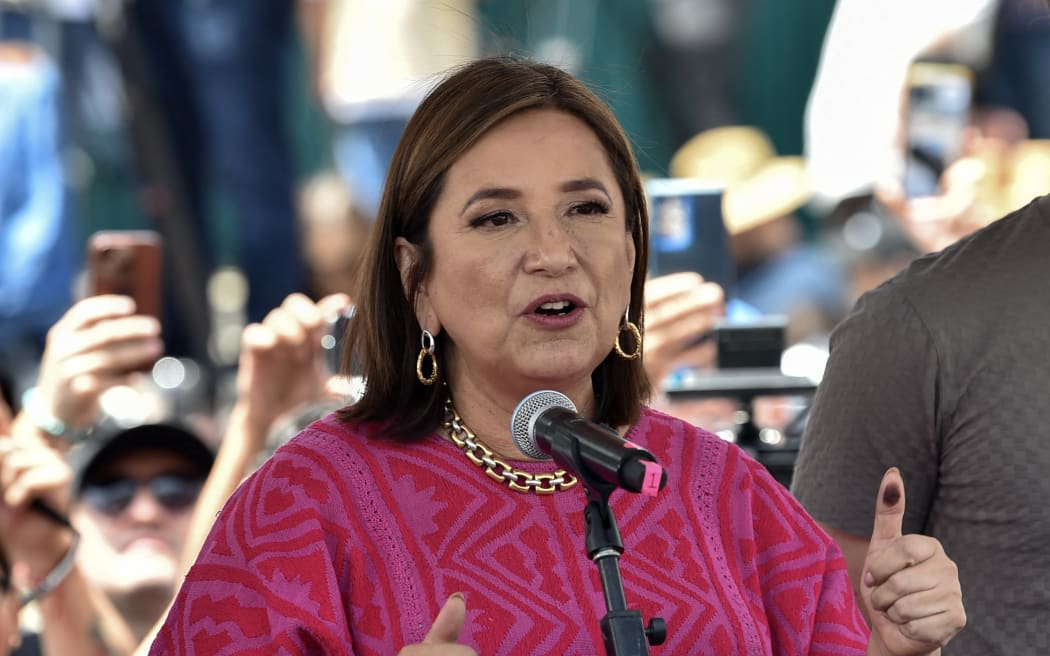 Mexico's opposition presidential candidate Xochitl Galvez (L), of the Fuerza y Corazon por Mexico coalition party, speaks after voting at the polling station in Mexico City during the general election on June 2, 2024. Mexicans go to the polls to elect its first woman president with the two front-runners -ruling-party candidate Claudia Sheinbaum and opposition hopeful Xochitl Galvez, both 61- seeking to break the glass ceiling in a country with a history of gender violence and inequality. (Photo by Rodrigo Oropeza / AFP)