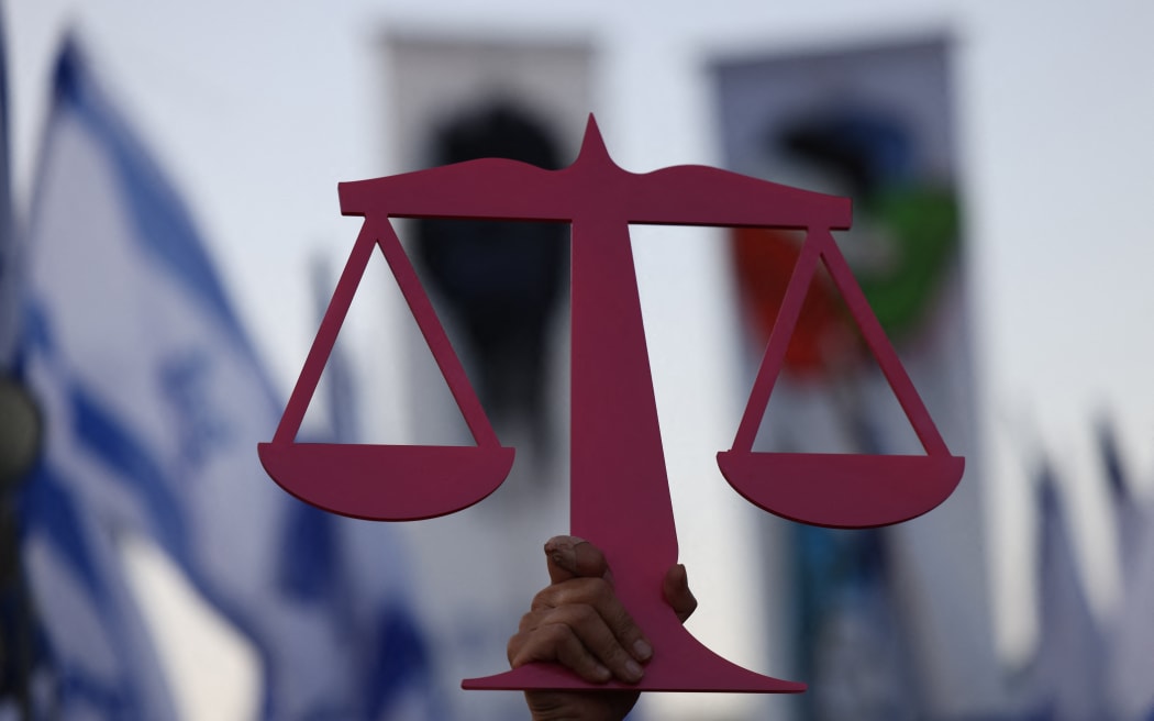 People attend a protest outside the Supreme Court in Jerusalem against the Israeli government's judicial overhaul plan on 11 September, 2023.
