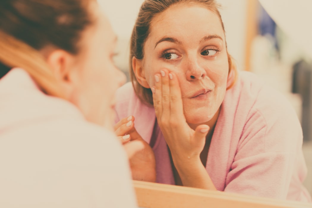 Woman cleaning her face
