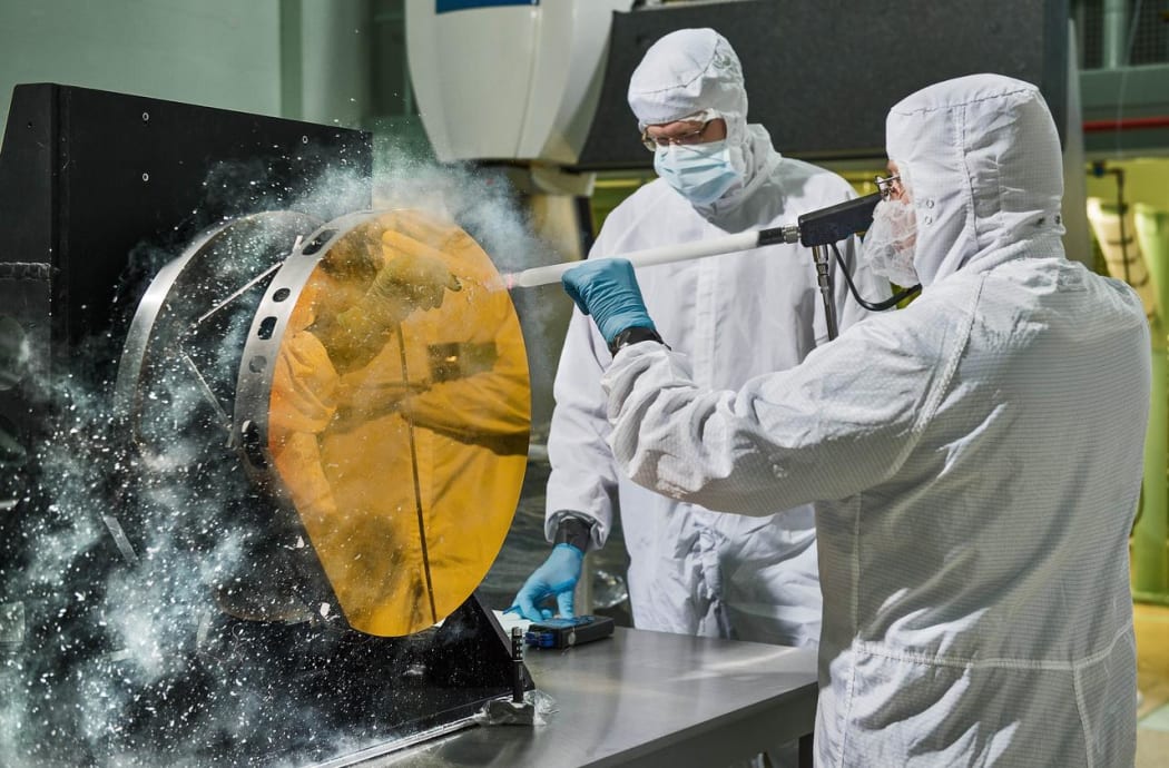engineers are practicing "snow cleaning'" on a test telescope mirror for the James Webb Space Telescope at NASA's Goddard Space Flight Center in Greenbelt, Maryland.