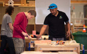 A tutor helps a student at the Weltec School of Construction