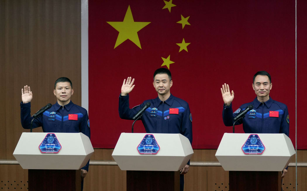 Astronauts Chen Dong, Chen Zhongrui, and Wang Jie at a news conference ahead of their Shenzhou-20 mission at Jiuquan Satellite Launch Center in Gansu, China, on 23 April.