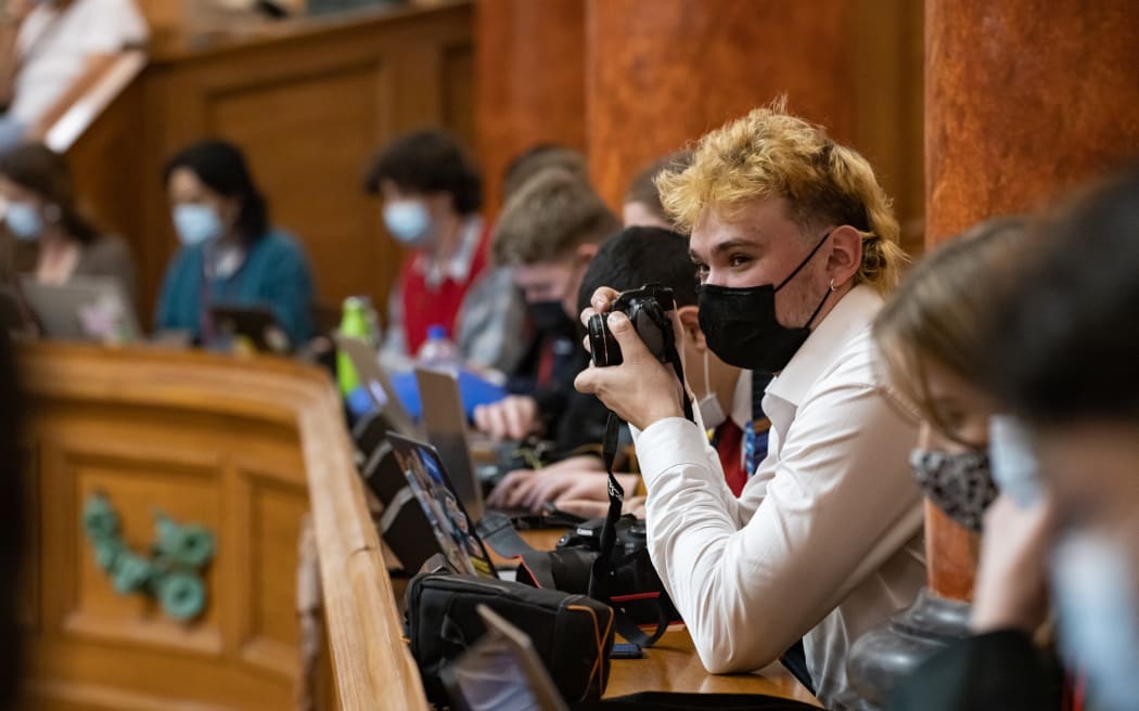 Among the Youth Press Gallery in the chamber YPG member Louis Collins looks for options for photographs.