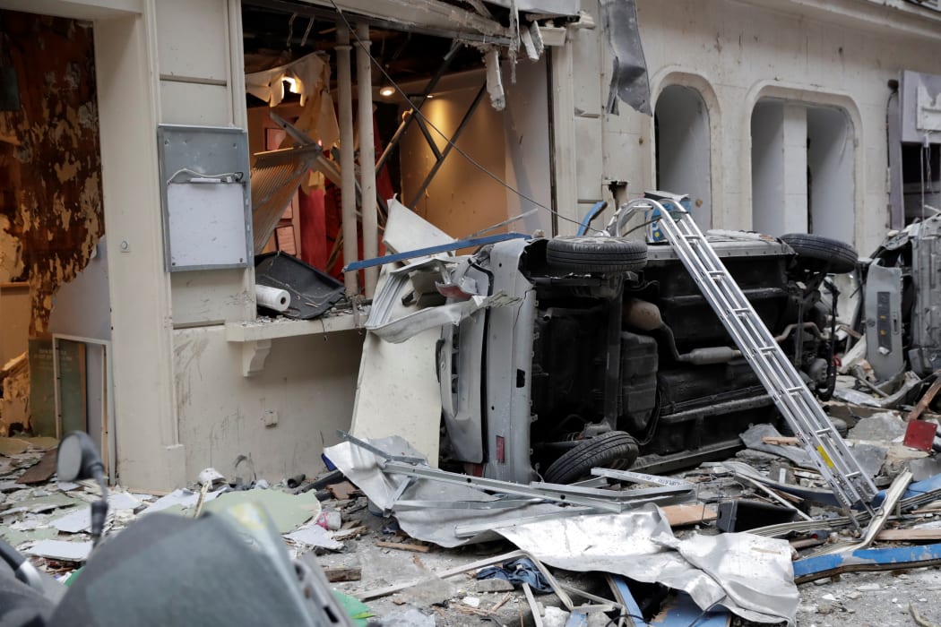 An overturned vehicle amid debris after the explosion in a Paris bakery on 12 January which killed four people. Police suspect the blast was caused by a gas leak.