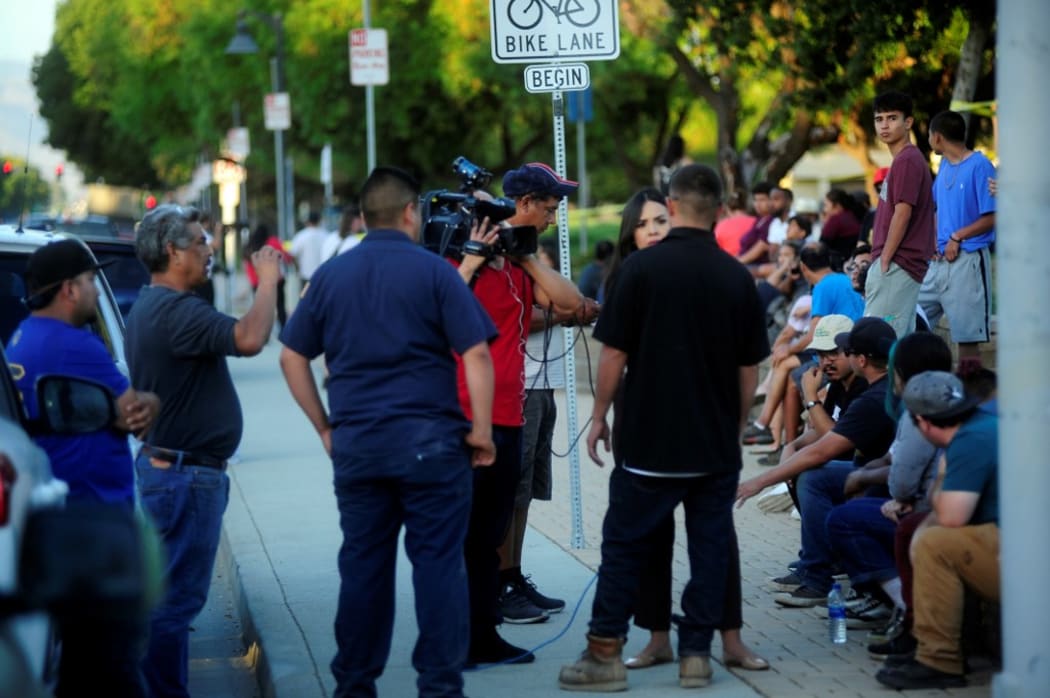 Residents gather at the Gilroy High School after mass shooting at the Garlic Festival in Gilroy, California.