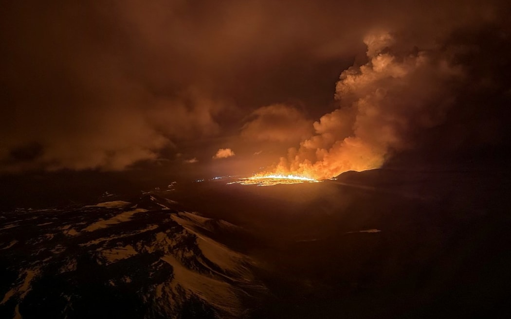 This handout picture released by the Icelandic Coast Guard on March 16, 2024 shows billowing smoke and flowing lava pouring out of a new fissure during a new volcanic eruption on the outskirts of the evacuated town of Grindavik, western Iceland. A volcanic eruption started on the Reykjanes peninsula in southwestern Iceland on Thursday, the third to hit the area since December, authorities said. (Photo by HANDOUT / Icelandic Coast Guard / AFP) / RESTRICTED TO EDITORIAL USE - MANDATORY CREDIT "AFP PHOTO /HANDOUT/ICELANDIC COAST GUARD " - NO MARKETING - NO ADVERTISING CAMPAIGNS - DISTRIBUTED AS A SERVICE TO CLIENTS