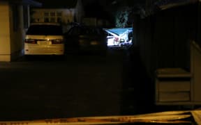 Debris from the explosion can be seen through the fence of a neighbouring property.