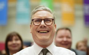 FILE - Britain's Labour Party leader Keir Starmer smiles as he sits in the audience at the launch of The Labour party's 2024 general election manifesto in Manchester, England, Thursday, June 13, 2024. The election will take place on July 4. The United Kingdom will hold its first national election in almost five years on Thursday, with opinion polls suggesting that Prime Minister Rishi Sunak’s Conservative Party will be punished for failing to deliver on promises made during 14 years in power. (AP Photo/Jon Super, File)