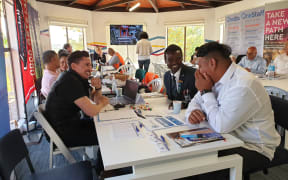 	Māngere College graduate Younis Ahamt Abdallah (in dark blue suit).