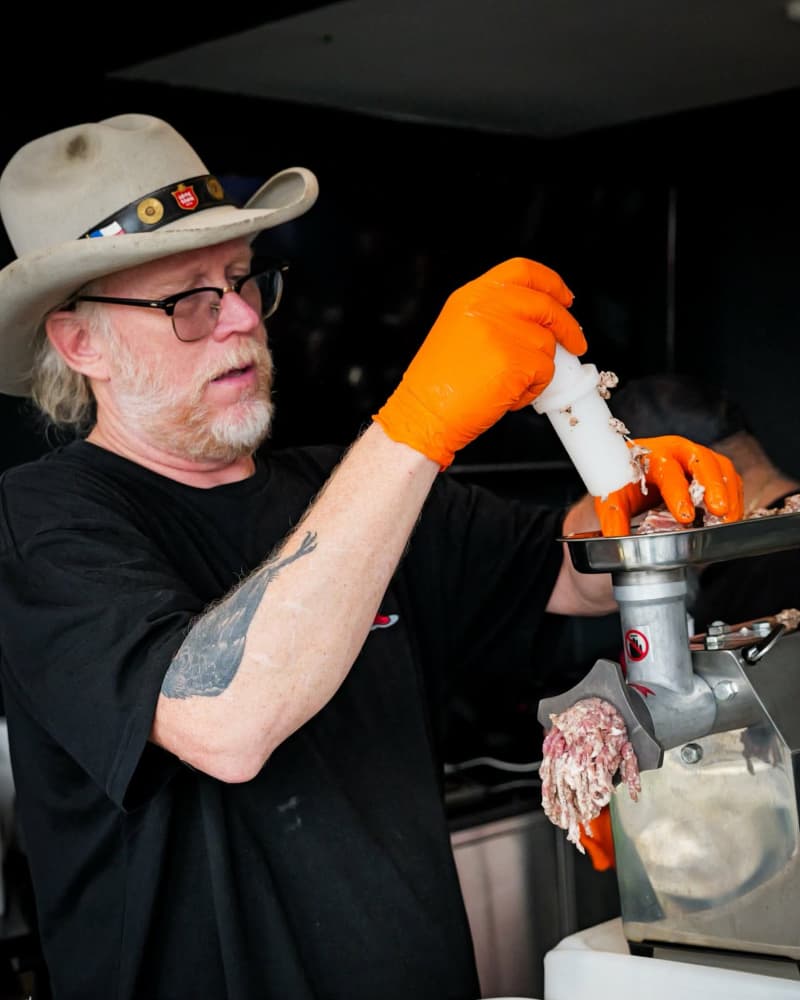 Bill Dumas tends to the meat grinder