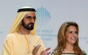 In this file photo taken on February 11, 2018 Sheikh Mohammed bin Rashid al-Maktoum and his wife Princess Haya bint al-Hussein are seen on stage during the opening of the World Government Summit in Dubai.