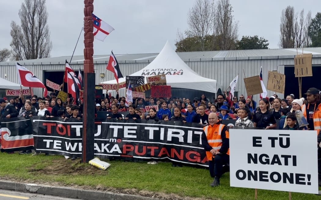 Ngāti Oneone people and supporters stand as one outside Te Pa Eketu Shed on Hirini St as the hapū starts an occupation which hapū chair Charlotte Gibson says will continue for “as long as it takes".