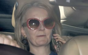 Britain's International Trade Secretary Liz Truss speaks on her phone as she is driven into the Houses of Parliament in central London on September 25, 2019. - British MPs returned to parliament on Wednesday following a momentous Supreme Court ruling that struck down Prime Minister Boris Johnson's decision to suspend the house weeks before the Brexit deadline. (Photo by Tolga AKMEN / AFP)