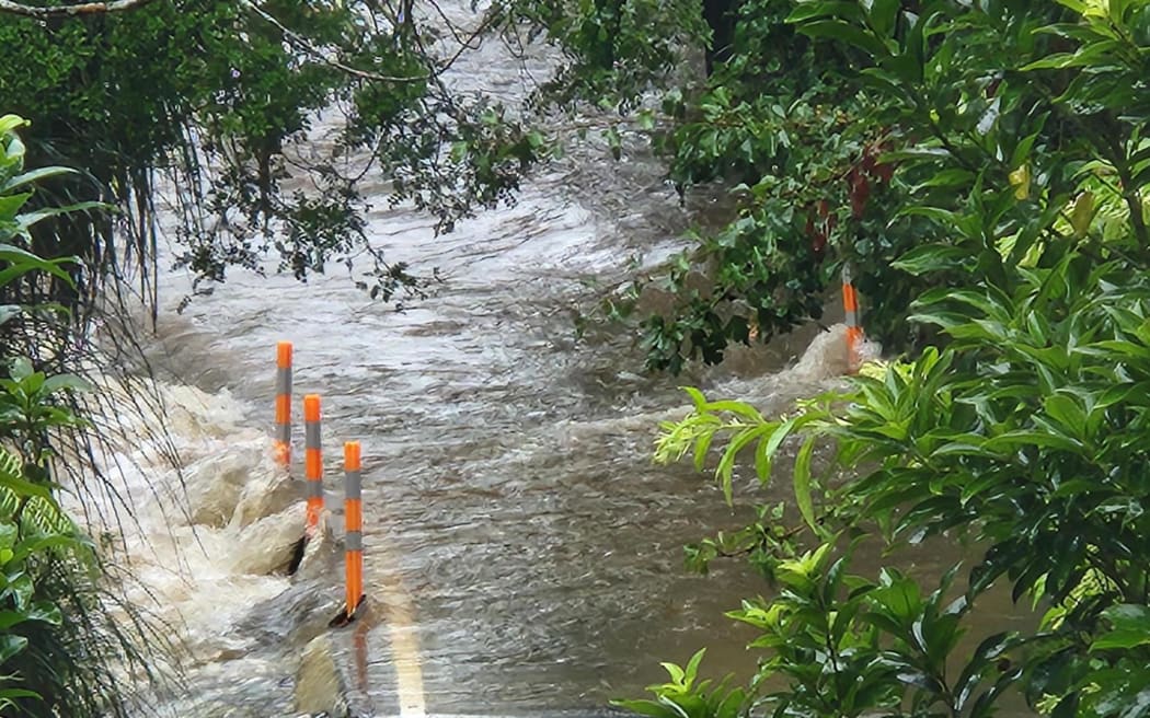 A section of Falls Road near the Mahurangi River is flooded over, it is in the area where a person and their vehicle is believed to have been swept into the river