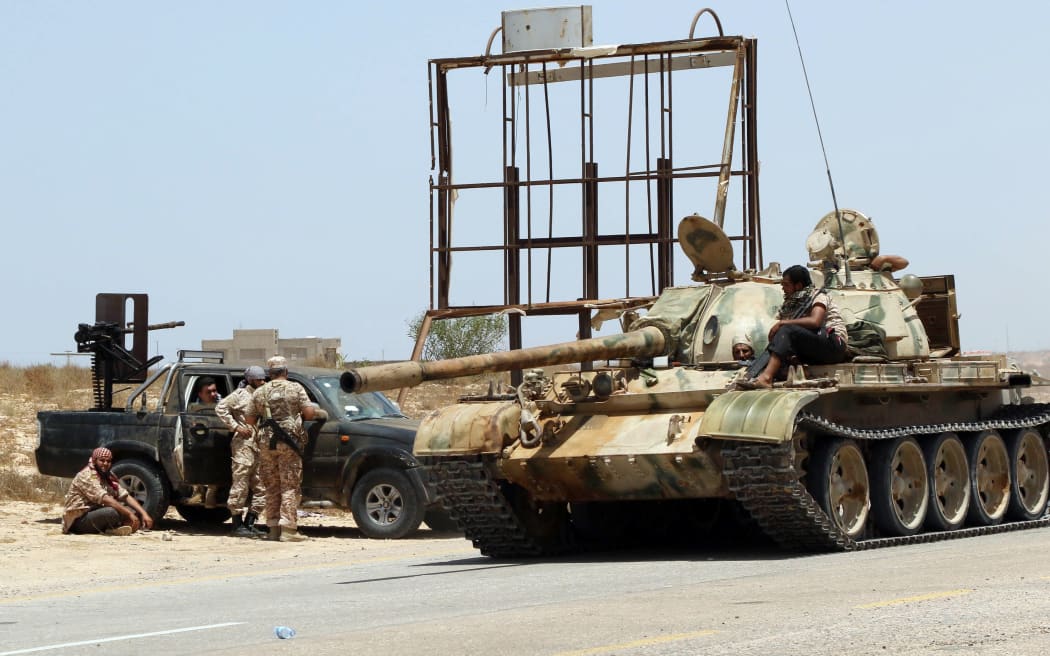 Forces loyal to Libya's UN-backed unity government gather around a tank in Sirte's centre as they advance to recapture the city from the Islamic State militant group.