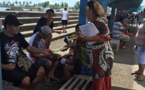 Samoa Solidarity International Group's Ruta Lealaitafea Westin handing out pamphlets to people at the Makeki in Apia. December 2017.