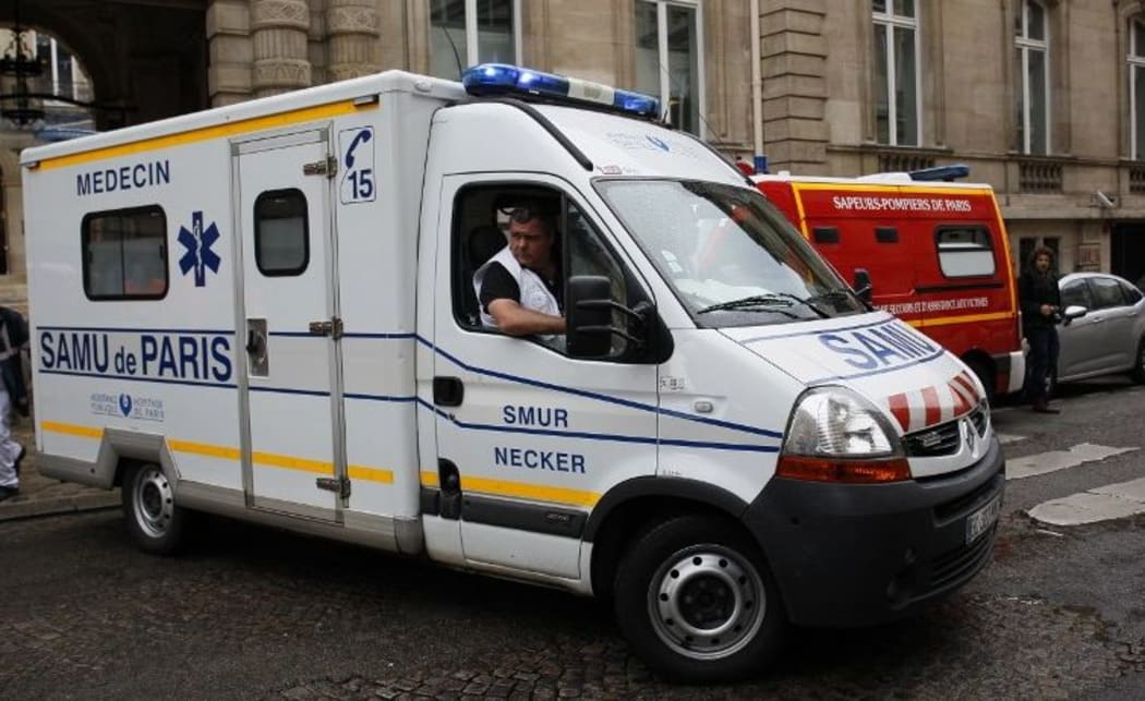 An ambulance leaves a building requisitioned to treat injured people, near the site of the accident at Parc Monceau in Paris.