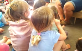children sit on the mat at an early childhood centre