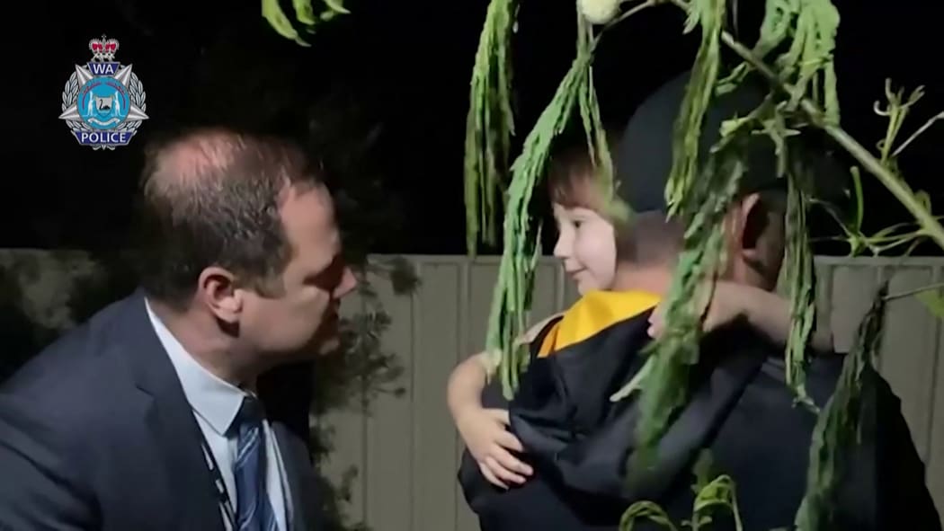 Cleo Smith being rescued by police in Carnarvon, Western Australia, shown in a screengrab of a video released by police.
