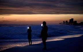 People visit the beach while waiting for Hurricane Michael in Panama City Beach, Florida.