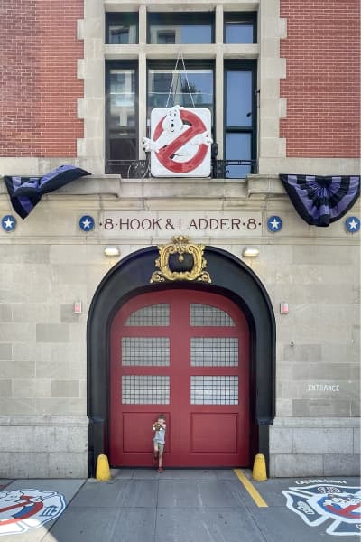 Mr Ed and a student from Piha Preschool outside the fire station in New York City made famous by the Ghostbusters movie.
