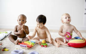 Babies playing together in a play room