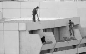 Armed police drop into position on a terrace directly above the apartments where between nine and 26 members of the Israeli Olympic team are being held hostage 9/5 by Arab "Black September" extremists.