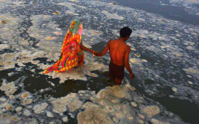 Hindu devotees bathing in the polluted river Ganges near Sangam in Allahabad.