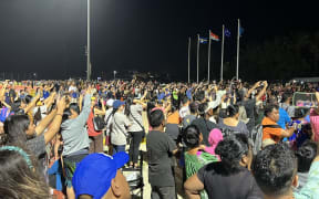 Thousands crowded into the track field for the Micronesian Games opening ceremony, focusing their phone cameras on the lighting of the Games flame by Marshall Islands wrestling star Waylon Muller.