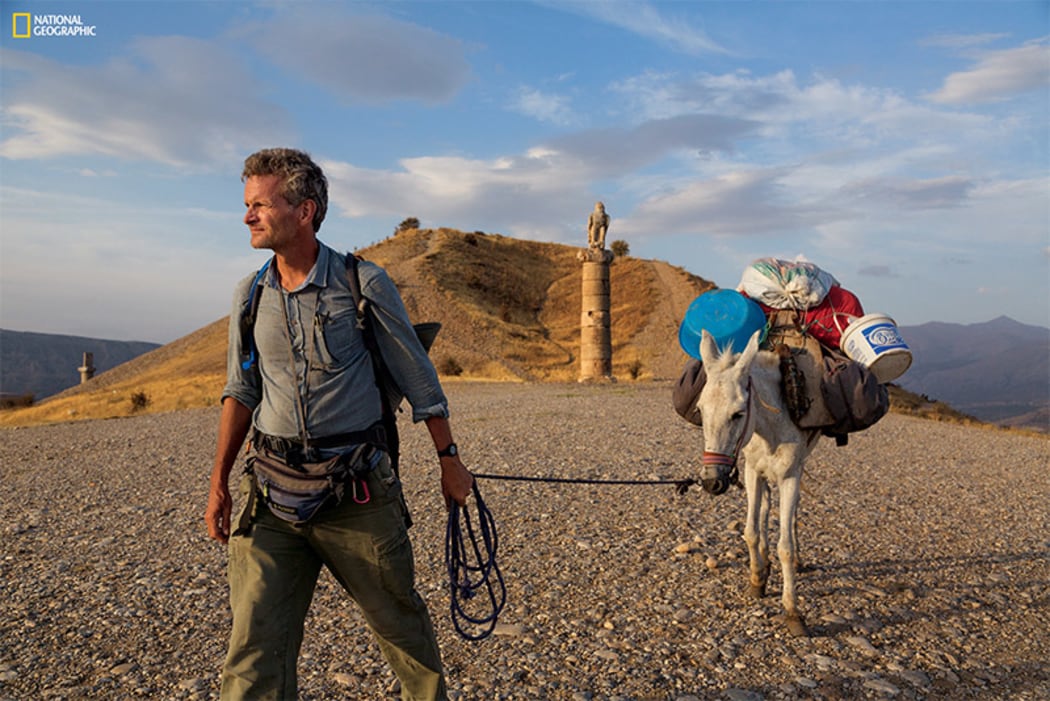 National Geographic Fellow Paul Salopek leads his mule past a royal tomb in east Turkey during his decade-long Out of Eden Walk
