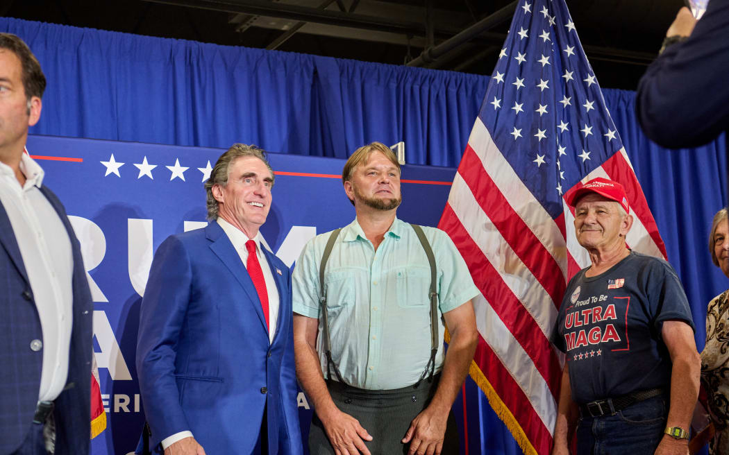 Republican Governor of North Dakota Doug Burgum poses with Kore Fisher, an Amish man from Lancaster County, Pennsylvania, in Morgantown, Pennsylvania,  on 12 September, 2024.