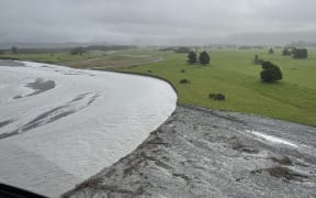 An aerial view of unprotected lower Waiho Flat farmland with a 'fresh' in the river in June.