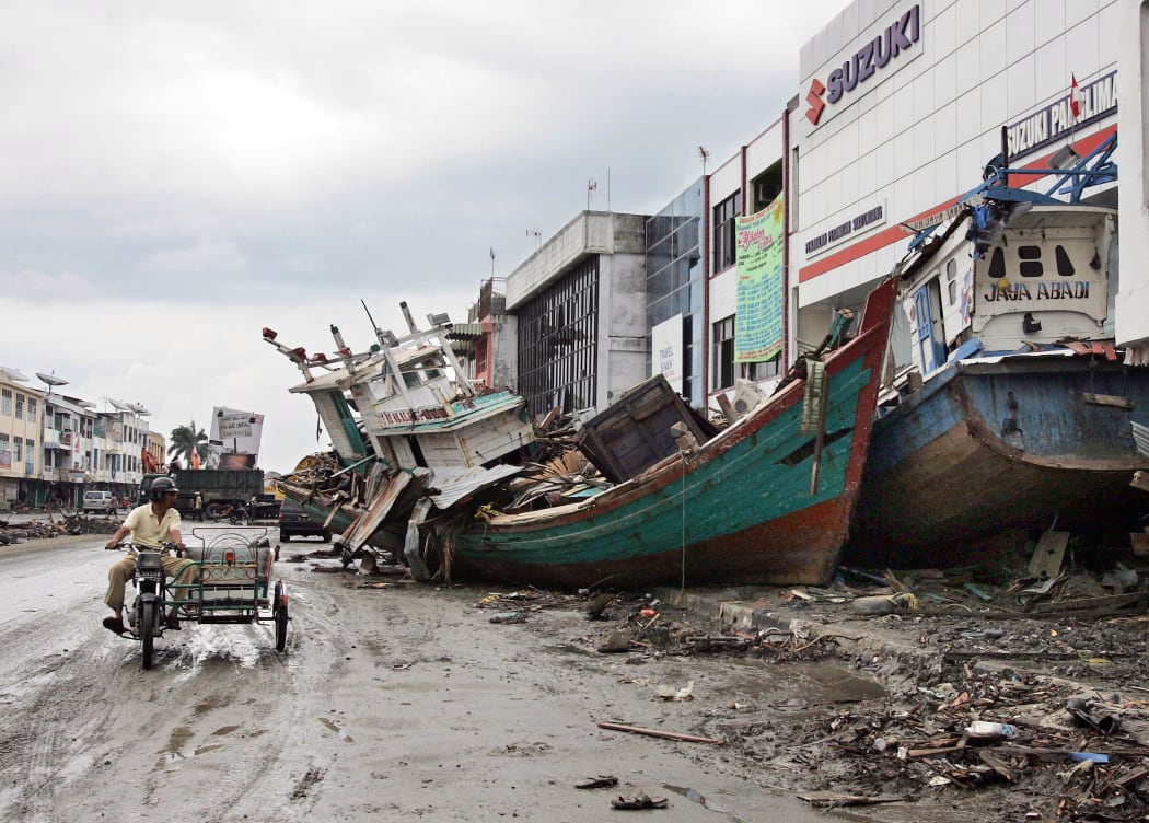 Ships sit in the middle of a street in downtown Banda Aceh, 08 January 2005, nearly two weeks after an earthquake and tsunami devastated the region.