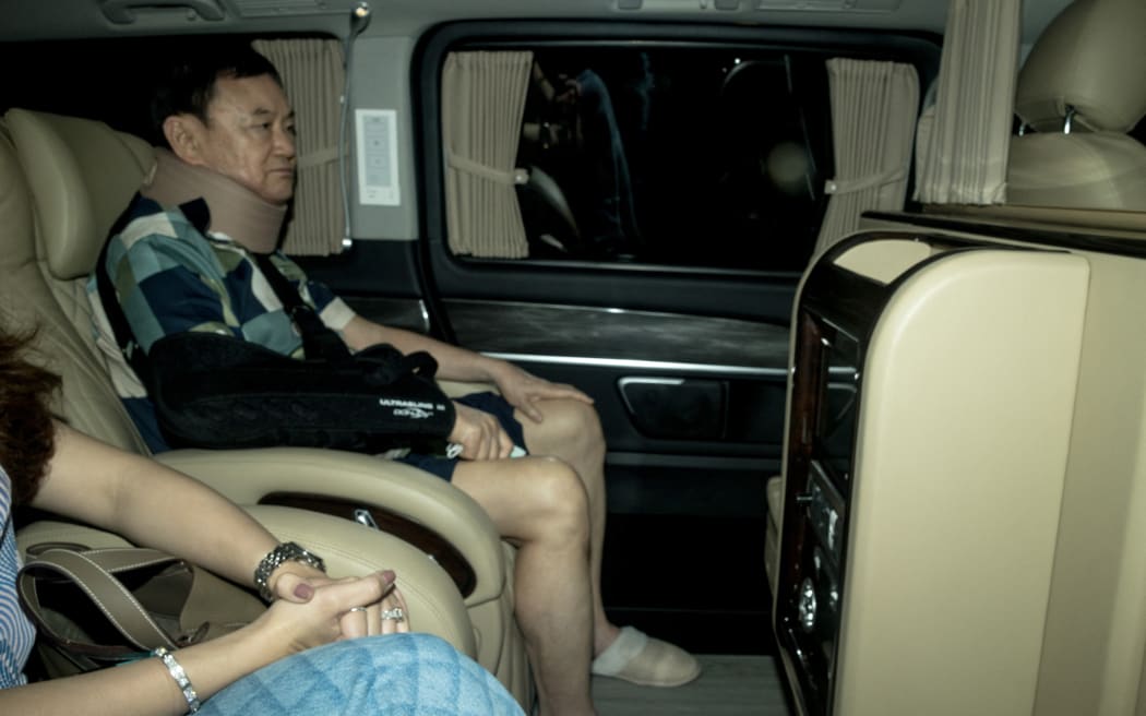 Thailand's former prime minister Thaksin Shinawatra arrives at his family compound after he was released from a police hospital in Bangkok on February 18, 2024. Jailed former Thai prime minister Thaksin Shinawatra left police hospital early February 18, just six months after his dramatic return to the kingdom from 15 years of self-imposed exile.
Thaksin, wearing a neck brace and sitting next to his daughter, could be seen through the window of a car leaving the police hospital in central Bangkok where he has spent the last half year. (Photo by Jack TAYLOR / AFP)