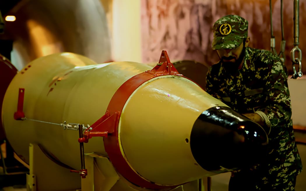 A handout picture released on March 8, 2016 by Sepah News, the online news site and public relations arm of Iran's Islamic Revolutionary Guard, shows a member of the Revolutionary Guards next to a missile launcher in an underground tunnel at an undisclosed location in Iran.