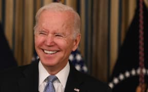 US President Joe Biden reacts as he delivers remarks on the passage of the Bipartisan Infrastructure Deal and the rule that will allow the passage of the Build Back Better Act in the State Dining Room at the White House in Washington, DC on November 6, 2021.