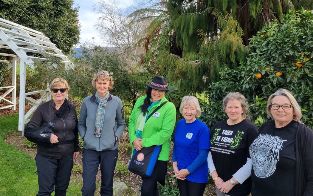 From Left - Maryann Eason, Jude Tisdall, Tiaki Ormsby, Janet Leggett, Nardene Berry, and Jo Wrigley, at Eason's farm homestead with Maungatautari Sanctuary Mountain behind.