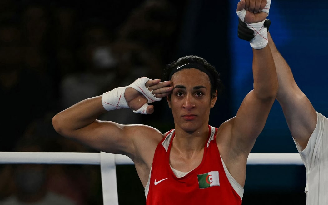 Algeria's Imane Khelif reacts after beating China's Yang Liu (Blue) in the women's 66kg final boxing match during the Paris 2024 Olympic Games at the Roland-Garros Stadium, in Paris on August 9, 2024. (Photo by Mauro PIMENTEL / AFP)