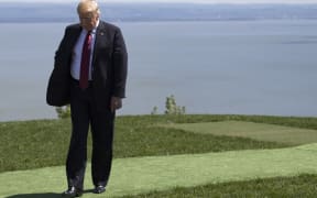 US President Donald Trump steps away after the family photo at the G7 Summit in La Malbaie, Canada.