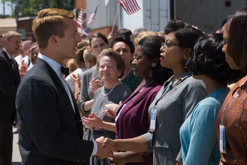 Johnson meets astronaut John Glenn (Glen Powell), the ‘good German’ in this story.