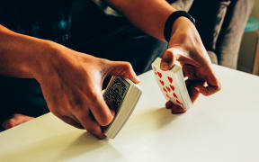 person shuffling cards