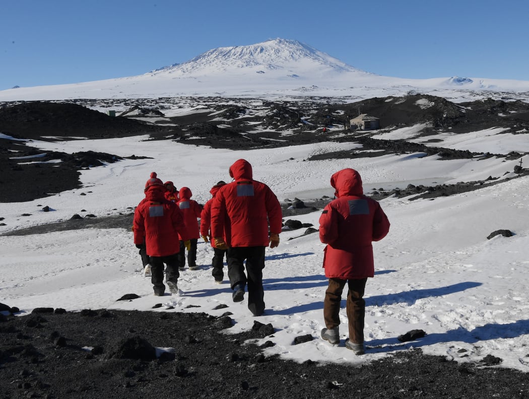 US Secretary of State John Kerry and members of his delegation hike towards the historic Shackleton hut near McMurdo Station during a visit to Antarctica on November 11, 2016.