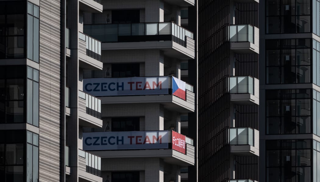 A Czech Republic flag and signage is displayed at the Olympic Village in Tokyo.
