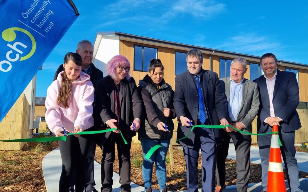 (L-R) is a Ngāi Tūāhuriri whānau member moving into one of their houses, Barry Bragg, Cate Kearney, another whānau member, Chris Bishop, Phil Mauger and Alex Skinner ŌCHT chairperson).
